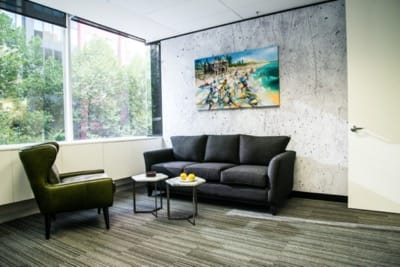 A trendy apartment's living room, with Forward, from the Bold carpet tile range.